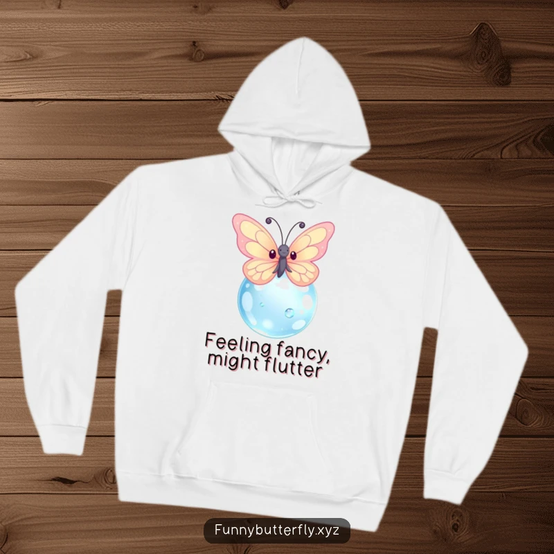 Funny and cute kawaii butterfly with sparkling wings hovering around a giant dewdrop, featured on a cozy hoodie.