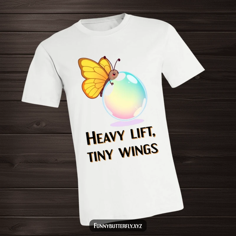 Funny T-shirt showing a comical butterfly straining to carry a giant, colorful dewdrop, depicting a funny, relatable moment of effort.